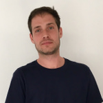 Photo of head and shoulders of man in black jumper